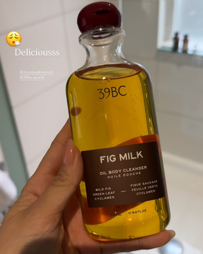 Hand holding a bottle of 39BC Fig Milk Bath & Shower Oil