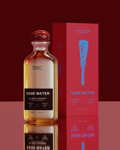 39BC Sage Water Bath & Shower Oil bottle and box on a reflective surface against a red background