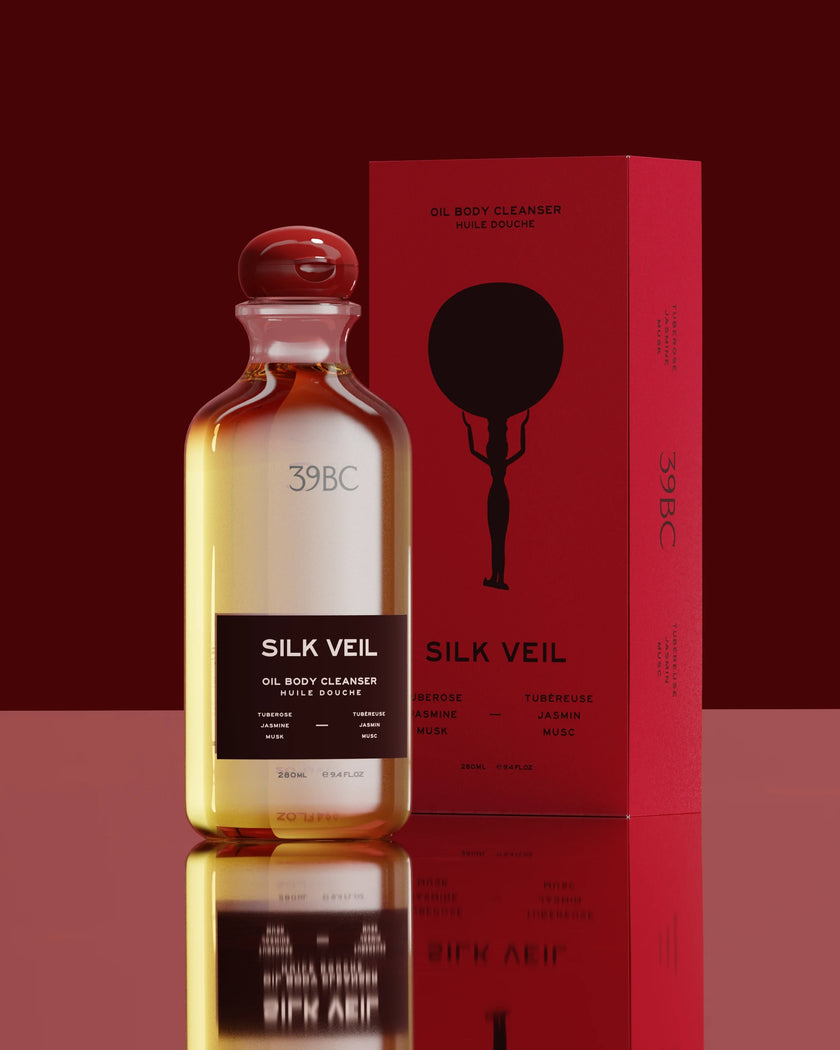 Bottle of 39BC Silk Veil oil body cleanser with red packaging on a reflective surface.