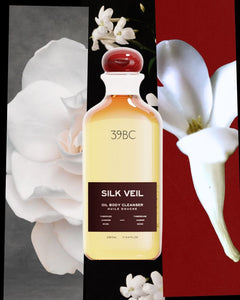 Bottle of 39BC Silk Veil Oil Body Cleanser with white flowers in the background